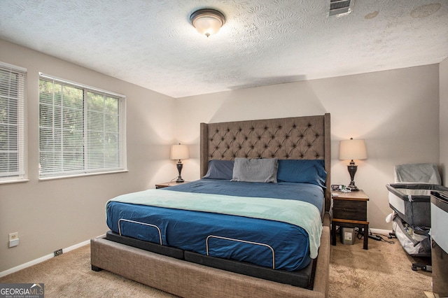 carpeted bedroom featuring a textured ceiling