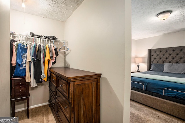 carpeted bedroom with a textured ceiling