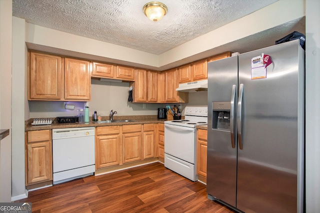 kitchen featuring dark wood-type flooring, white appliances, sink, and a textured ceiling