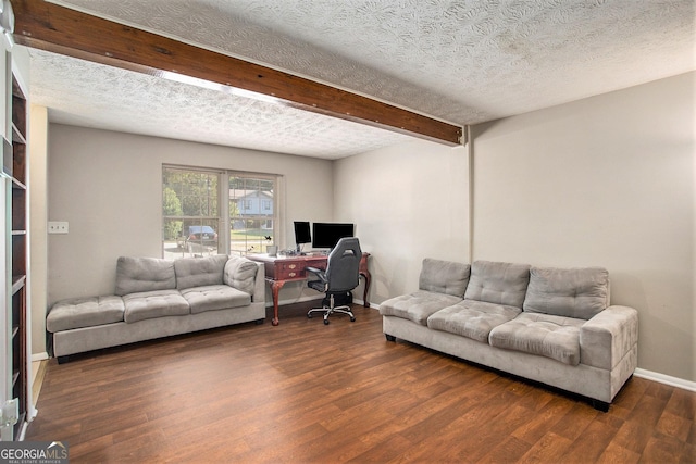 living room with dark hardwood / wood-style floors, a textured ceiling, and beam ceiling