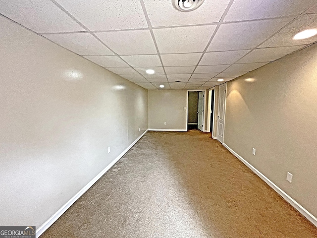 basement with carpet floors and a drop ceiling