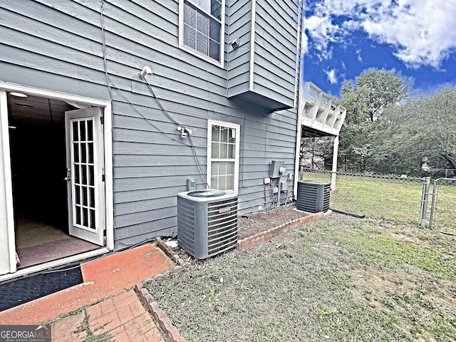 view of home's exterior featuring a yard and central AC