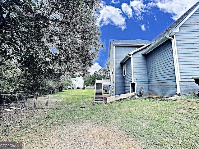 view of yard with fence and stairway