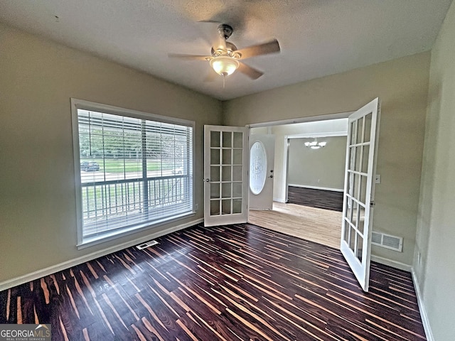 interior space featuring dark hardwood / wood-style flooring, a textured ceiling, french doors, and ceiling fan