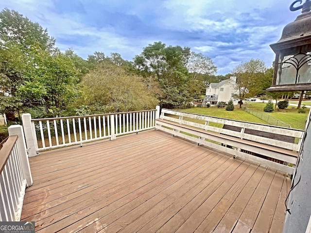 wooden terrace featuring a yard