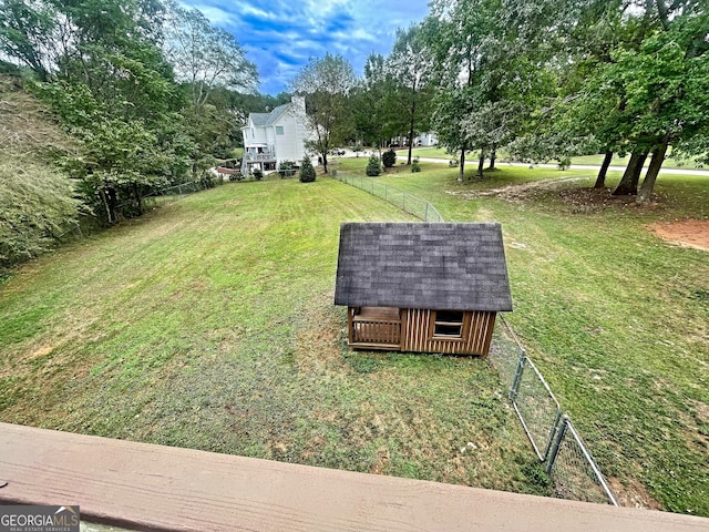 view of yard featuring an outbuilding and fence