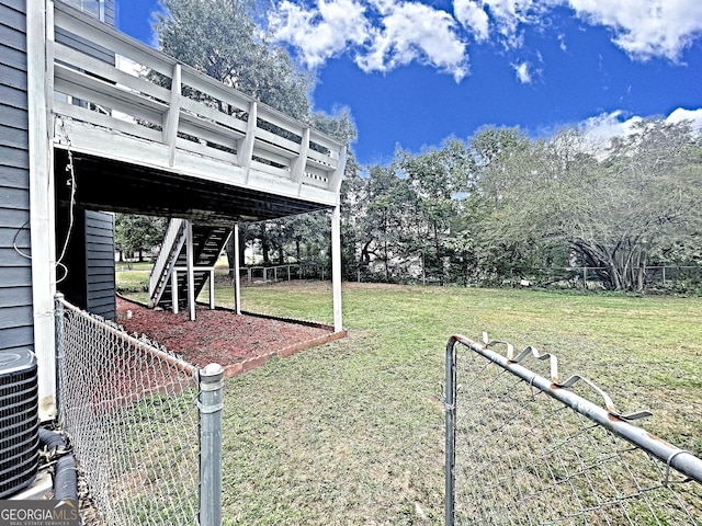 view of yard featuring fence and central AC