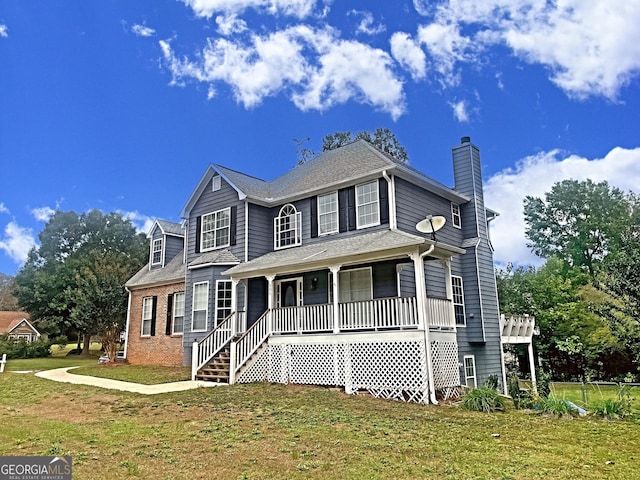 view of front facade with a front lawn and a porch