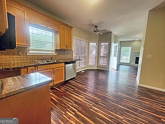 kitchen with sink, tasteful backsplash, stainless steel dishwasher, dark hardwood / wood-style flooring, and ceiling fan