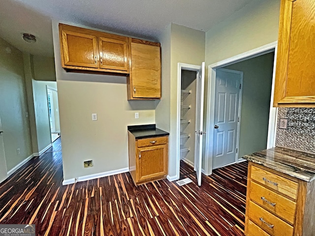 kitchen with dark hardwood / wood-style flooring and decorative backsplash