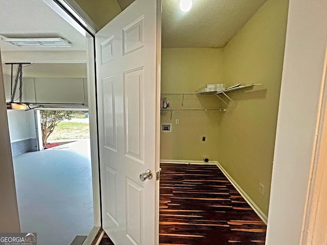 clothes washing area with hookup for a washing machine, laundry area, wood finished floors, visible vents, and baseboards