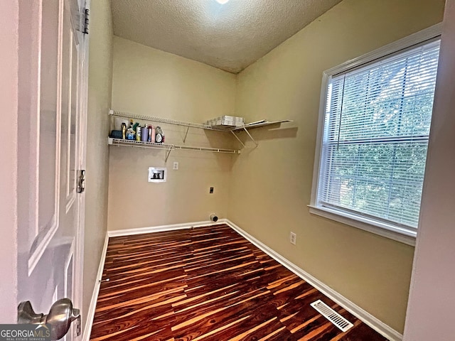 clothes washing area with washer hookup, hardwood / wood-style floors, hookup for an electric dryer, and a textured ceiling