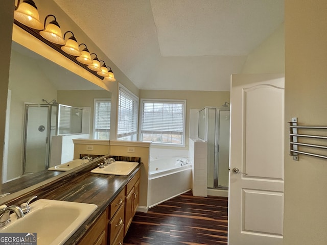 full bath with a garden tub, wood finished floors, a sink, and a shower stall