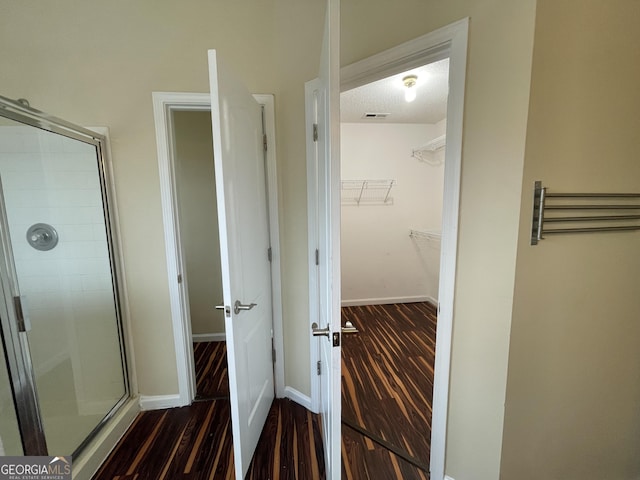 interior space with visible vents, dark wood finished floors, and baseboards