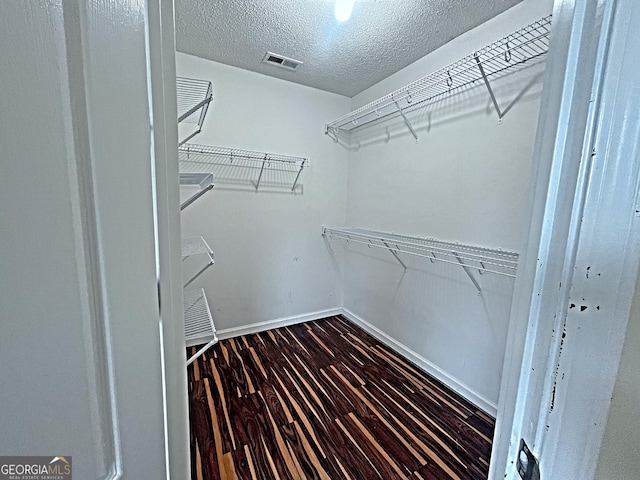 spacious closet with visible vents and wood finished floors