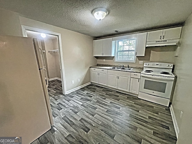 kitchen featuring dark wood-style flooring, white cabinets, a sink, white appliances, and under cabinet range hood