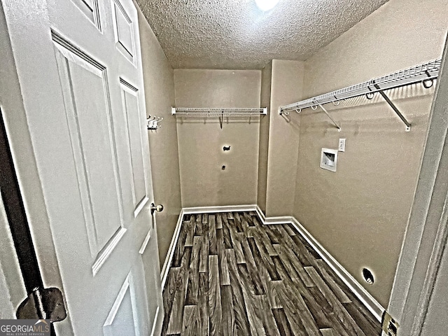 washroom with a textured ceiling, hookup for a washing machine, hookup for an electric dryer, laundry area, and dark wood-type flooring