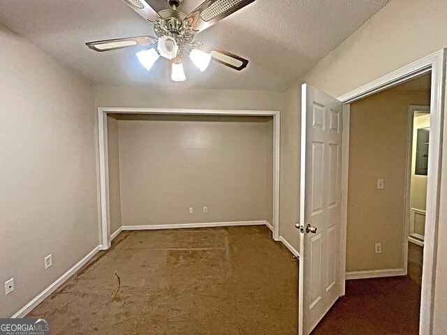 unfurnished room with ceiling fan, carpet floors, and a textured ceiling