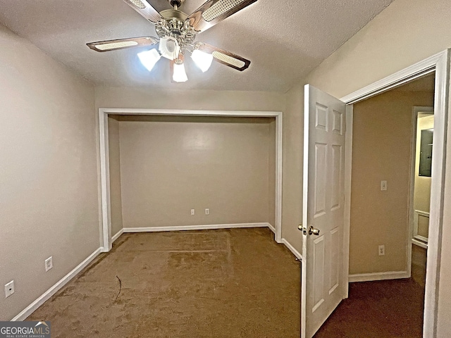 unfurnished bedroom with ceiling fan, dark carpet, and a closet