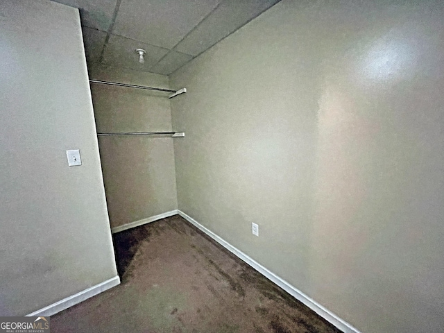 spacious closet with a paneled ceiling