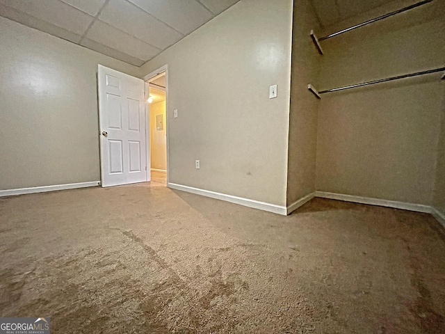 unfurnished bedroom featuring carpet floors and baseboards