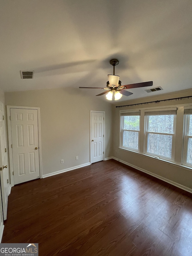 unfurnished room with dark hardwood / wood-style floors and ceiling fan