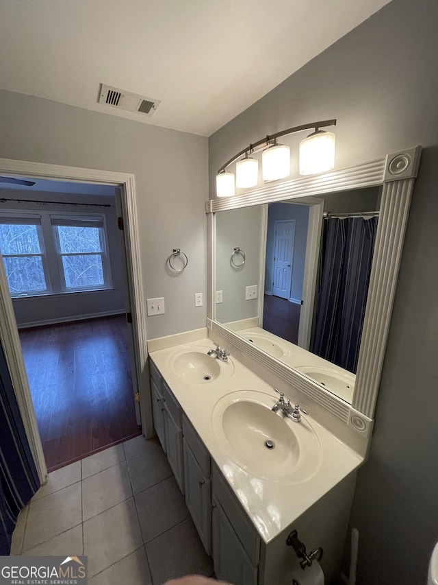 bathroom featuring tile patterned flooring and vanity