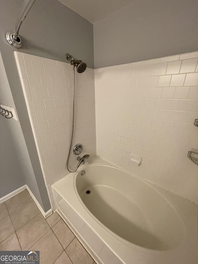 bathroom featuring tiled shower / bath and tile patterned flooring