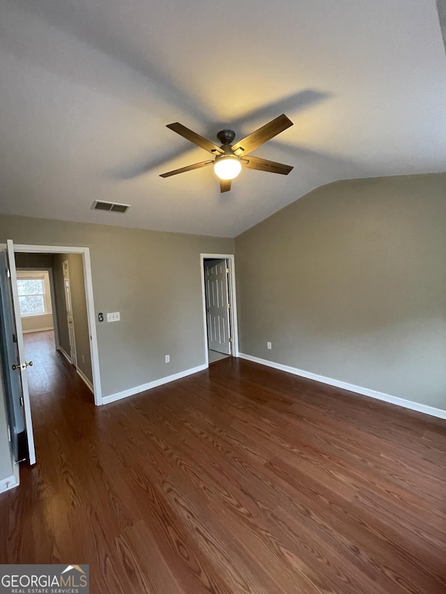 unfurnished room with vaulted ceiling, dark hardwood / wood-style floors, and ceiling fan