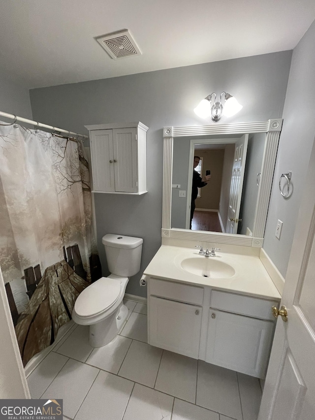 bathroom featuring tile patterned flooring, vanity, a shower with shower curtain, and toilet