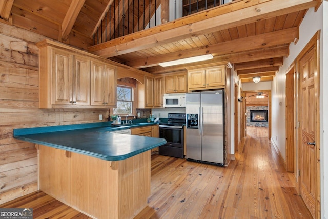 kitchen with a breakfast bar, sink, wooden ceiling, beamed ceiling, and stainless steel appliances