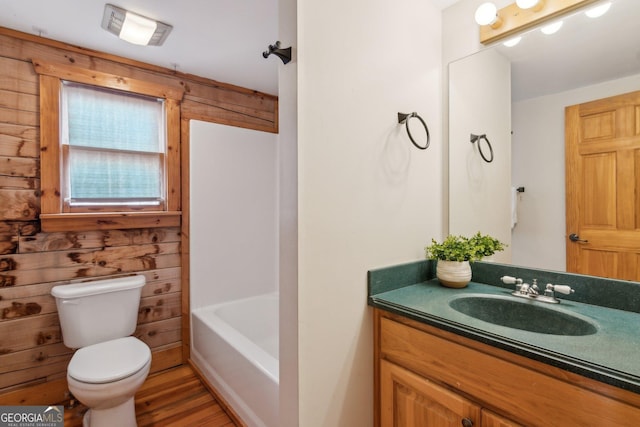 bathroom with vanity, toilet, and wood-type flooring