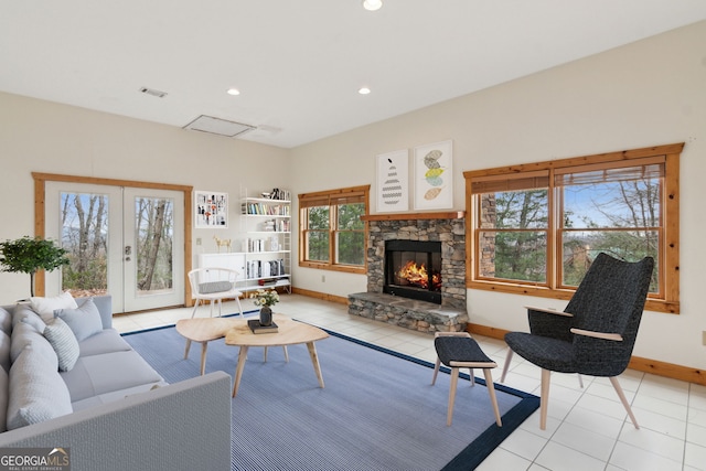 tiled living room with a fireplace and french doors