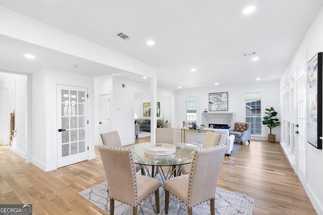 dining room with light hardwood / wood-style flooring and french doors