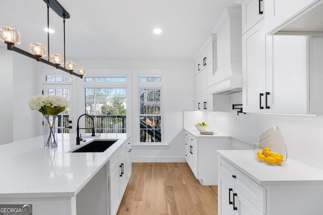 kitchen featuring white cabinetry and sink