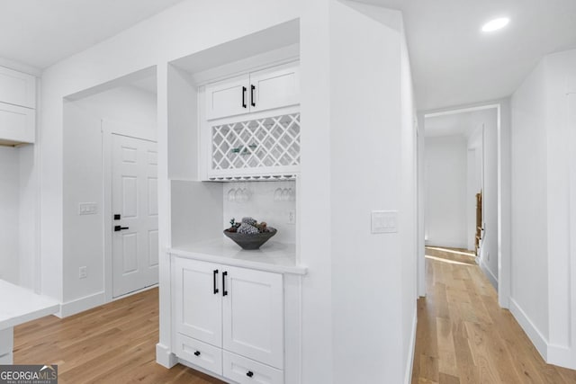 corridor with light hardwood / wood-style flooring