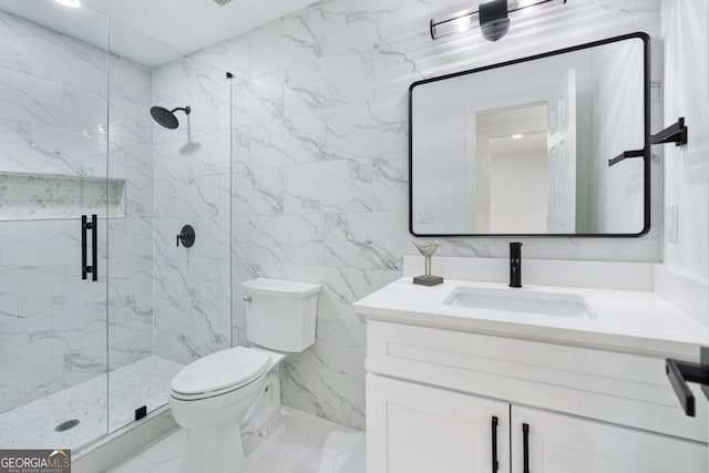 bathroom with a shower with door, vanity, tile walls, and toilet