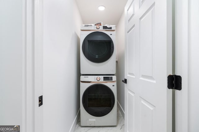 clothes washing area with stacked washer / dryer