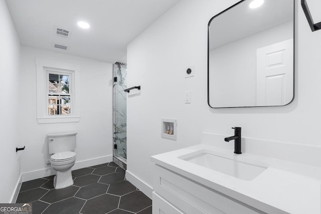 bathroom featuring vanity, tile patterned floors, a shower with door, and toilet