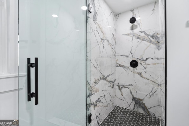 bathroom with a shower with shower door