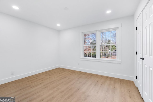 unfurnished bedroom with light hardwood / wood-style floors and a closet