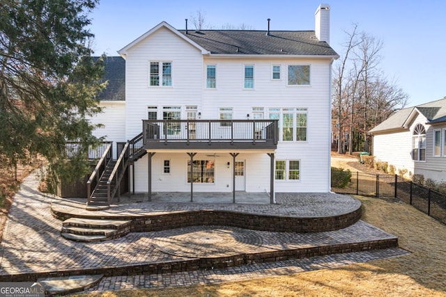 rear view of house with a deck, ceiling fan, and a patio area