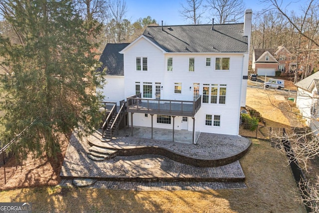 back of house with a deck and a patio area