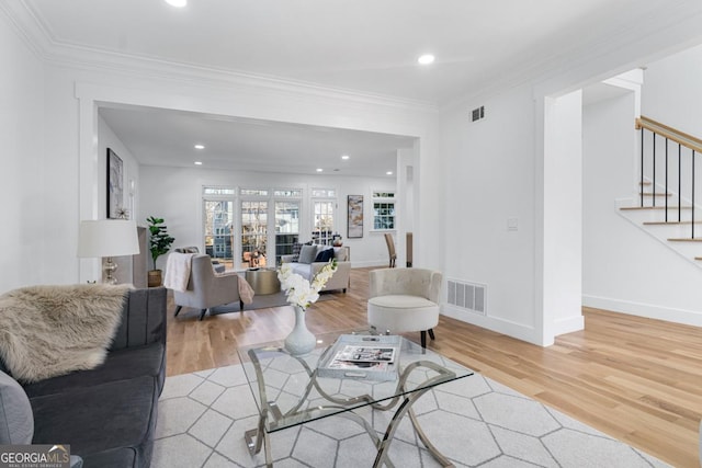 living room featuring crown molding and hardwood / wood-style floors