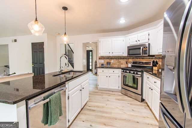4222 Honey Creek Way, Powder Springs, GA 30127 - kitchen featuring appliances with stainless steel finishes, white cabinetry, light wood finished floors, tasteful backsplash, and pendant lighting