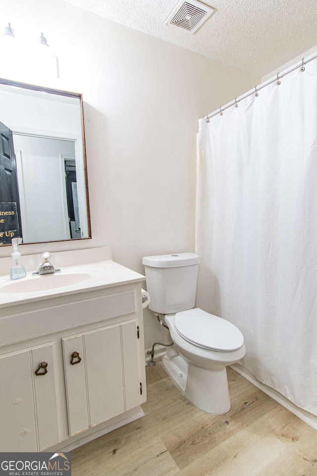 4222 Honey Creek Way, Powder Springs, GA 30127 - bathroom featuring wood finished floors, vanity, a textured ceiling, and curtained shower