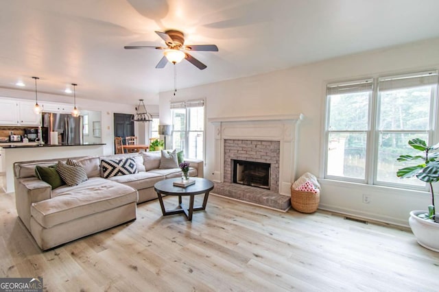 4222 Honey Creek Way, Powder Springs, GA 30127 - living room featuring ceiling fan, light wood finished floors, and a brick fireplace
