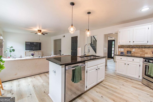 4222 Honey Creek Way, Powder Springs, GA 30127 - kitchen with appliances with stainless steel finishes, light wood-style floors, a ceiling fan, backsplash, and white cabinets