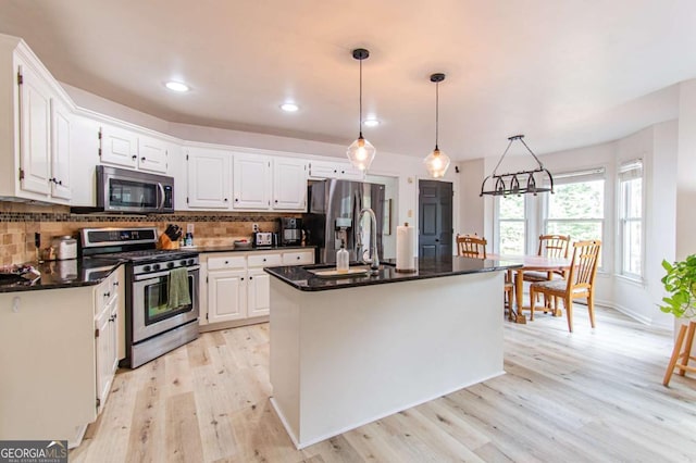 4222 Honey Creek Way, Powder Springs, GA 30127 - kitchen with stainless steel appliances, light wood-type flooring, white cabinetry, backsplash, and recessed lighting