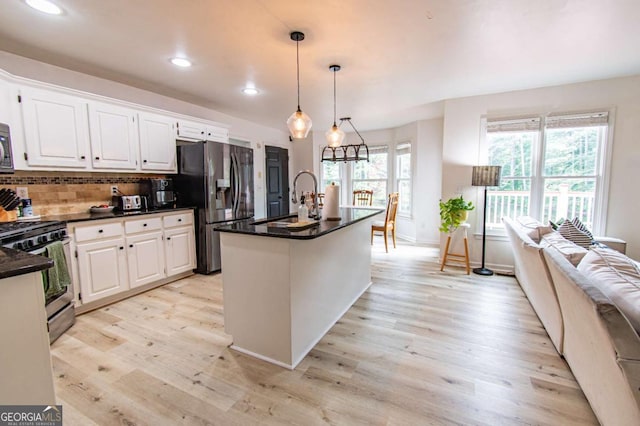 4222 Honey Creek Way, Powder Springs, GA 30127 - kitchen with stainless steel appliances, light wood-style flooring, plenty of natural light, white cabinetry, and recessed lighting